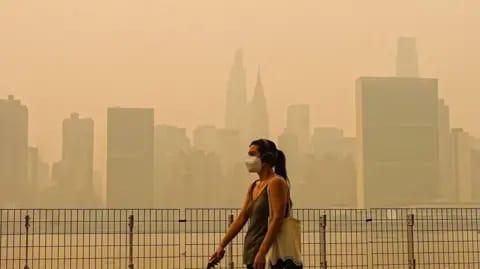 Selcuk Acar/Anadolu via Getty Images Smoke from massive wildfires in Canada engulfed the New York City skyline, reducing visibility and casting an orange haze over the New York City