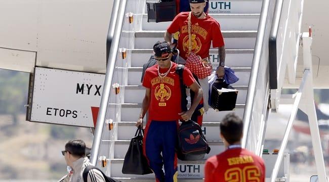 Spanish forward Lamine Yamal smiles as he disembarks from the plane