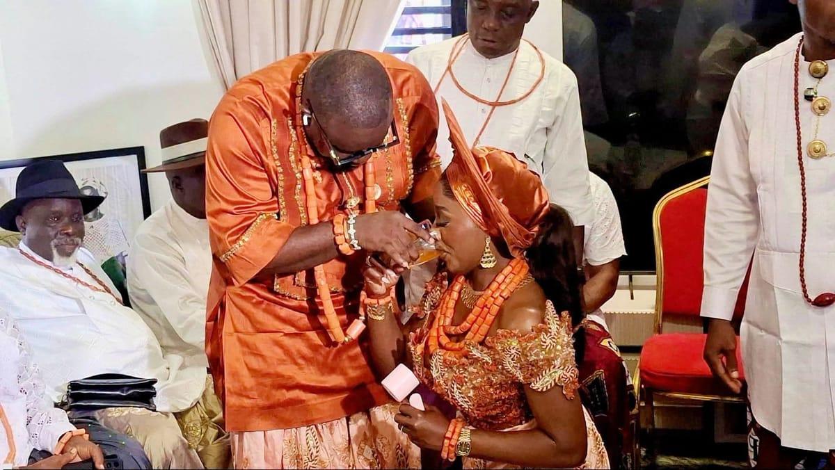 The couple exchanging vows in the presence of family and friends
