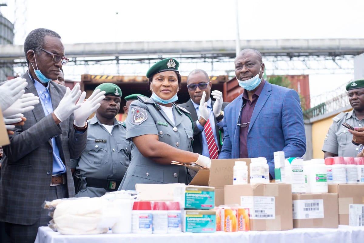 Comptroller Salamatu Atuluku (second left), Customs Area Controller, Port Harcourt Area I Command, participates in the handover ceremony of intercepted expired pharmaceutical products to NAFDAC.