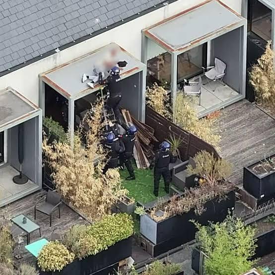 Greater Manchester Police officers at the scene of the prolonged rooftop incident in Salford.
