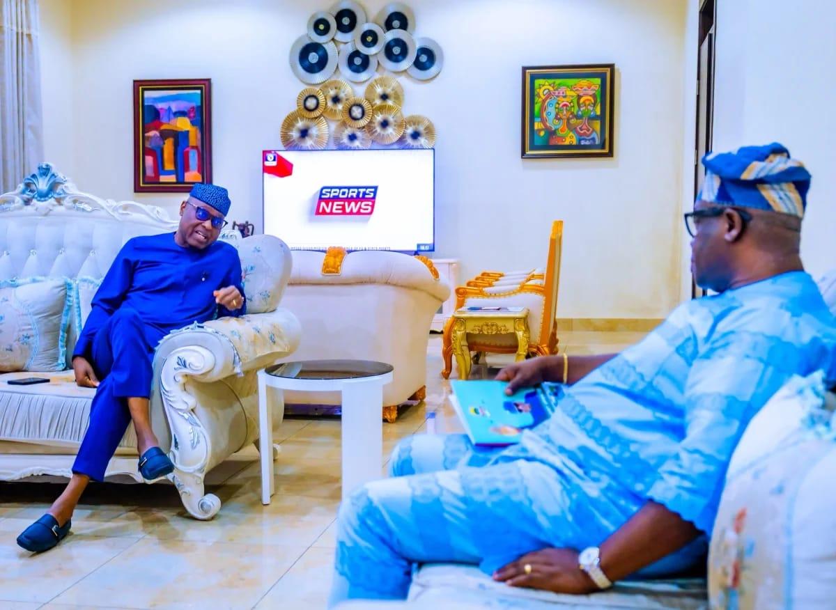 Ekiti State Governor Biodun Oyebanji (left) and Dr. Wole Oluyede of the PDP discussing state and national development.
