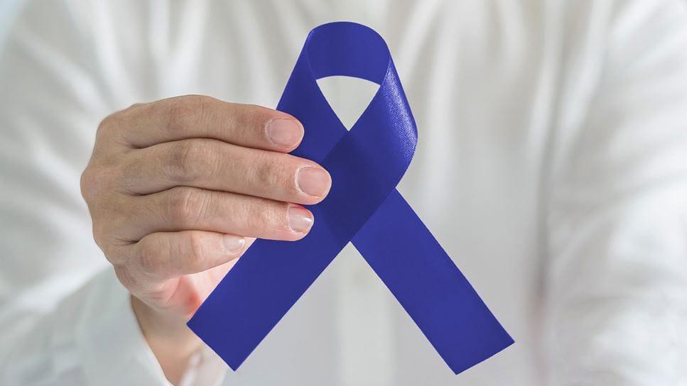 Medical professionals discussing colorectal cancer, highlighting awareness and navigation.