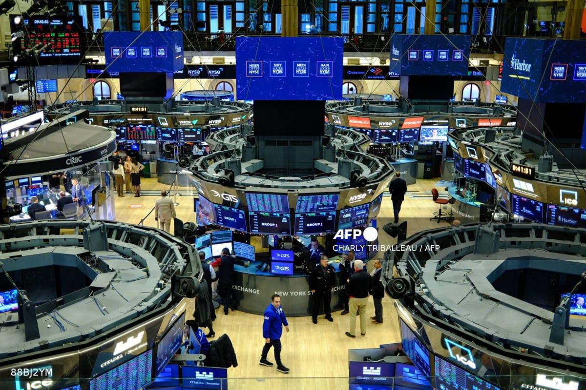 Traders actively working on the floor of the New York Stock Exchange at the opening bell in New York on December 16, 2025.